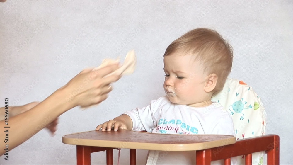 Mother wipes handles to the child a towel. Mother wipes handles to the child a towel.