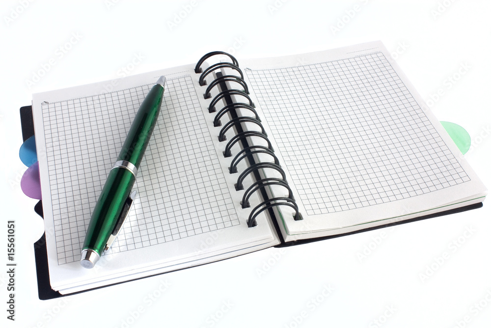Open notebook and green pen Open notebook and green pen