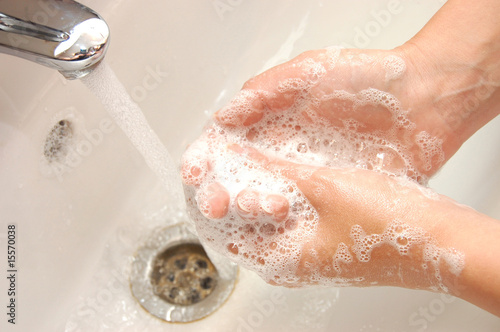 woman washing hand under running water