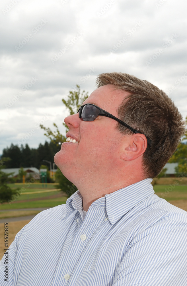 Profile of a happy young man in sunglasses. Profile of a happy young man in sunglasses.