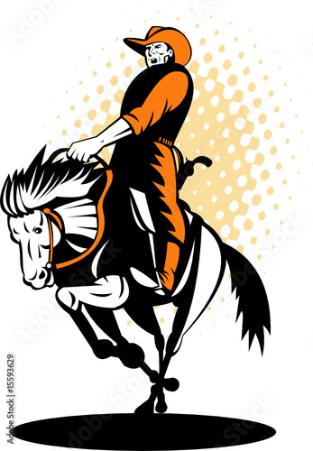 Rodeo cowboy riding a horse in full gallop