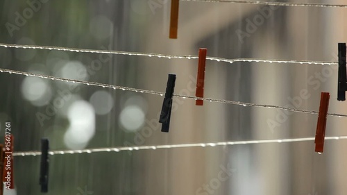 Rain falling over clothesline with clothespins