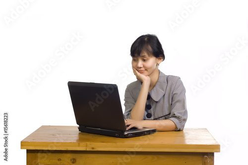 Business Woman Using Laptop on White Background and Smiling © Leo Lintang