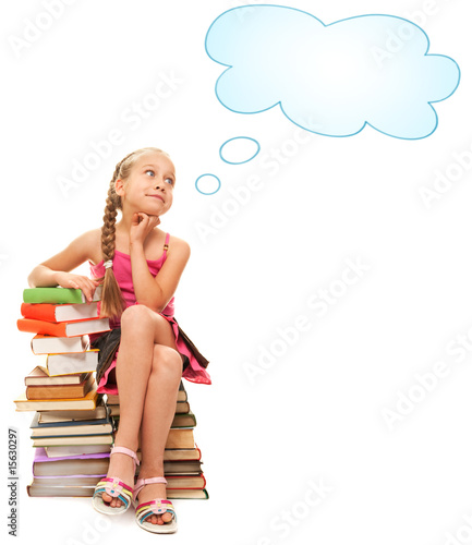 Little schoolgirl sitting on a stack of books....