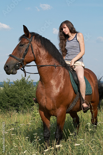 Girl sits on horseback