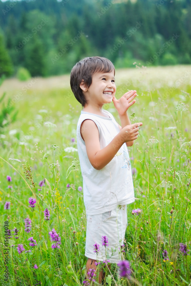 Cute little boy on green grass in nature Cute little boy on green grass in nature