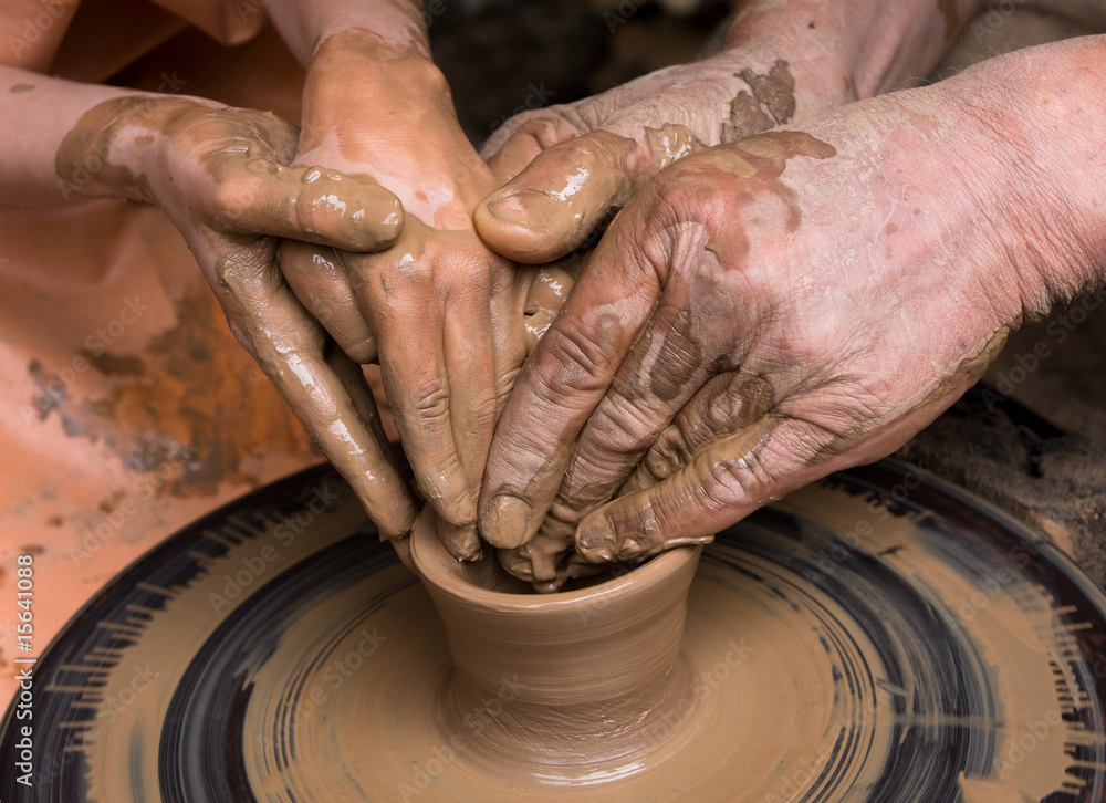 Close-up of potter turning a pot on a potter's wheel