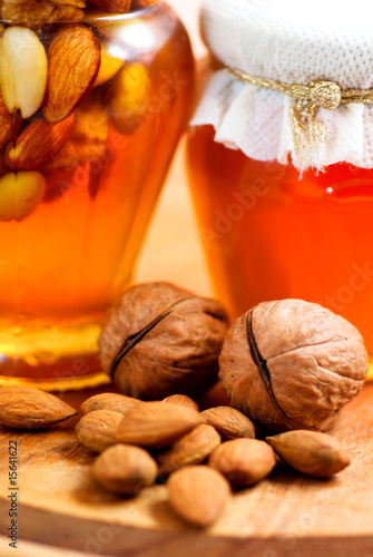 Honey with almonds and walnuts photo