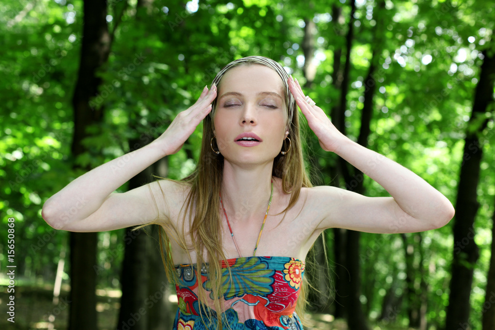 listen summer - young woman with closed eyes in park