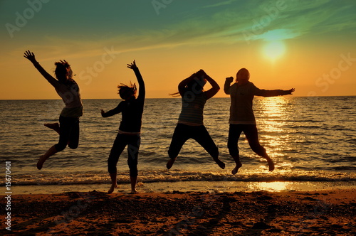 Teens jumping at beach