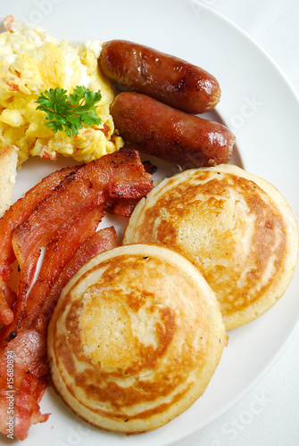 A Breakfast Meal Of Pancake Bacon Sausage And Scrambled Egg Stock Photo Adobe Stock