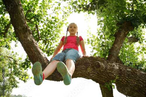 Little girl climbed on tree