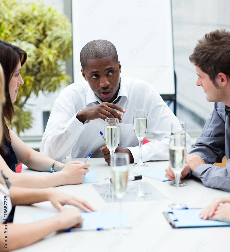 Ethnic manager speaking in a meeting with champagne Ethnic manager speaking in a meeting with champagne