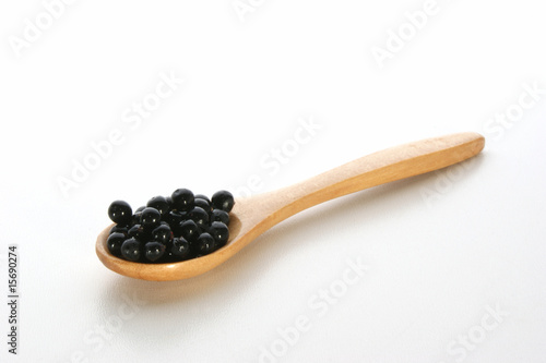 elderberries on a timber spoon