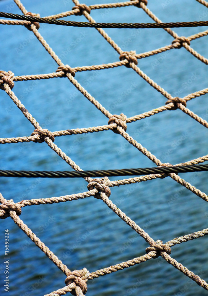 View through the safety net at the blue sea backround