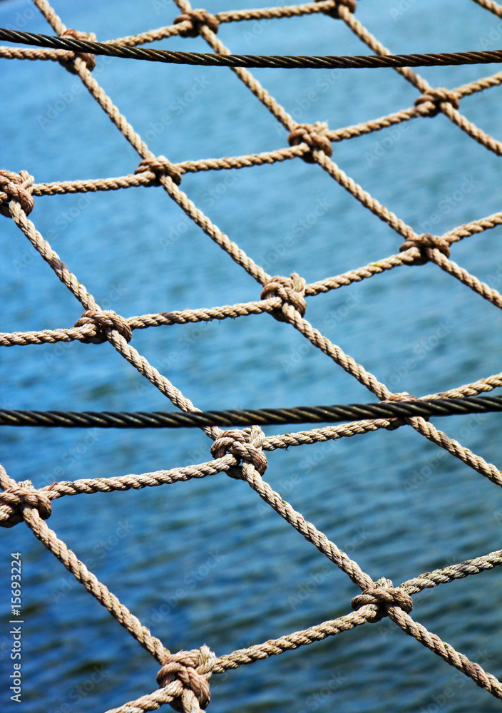 View through the safety net at the blue sea backround View through the safety net at the blue sea backround