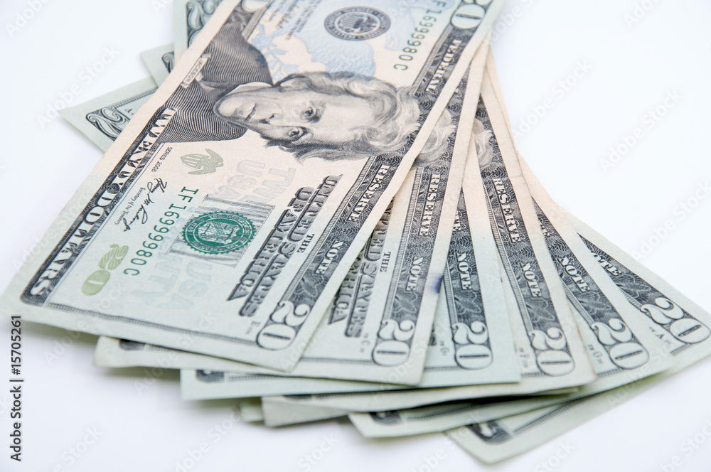 Pile of 20 dollar bills, isolated on white, focus on faces Pile of 20 dollar bills, isolated on white, focus on faces