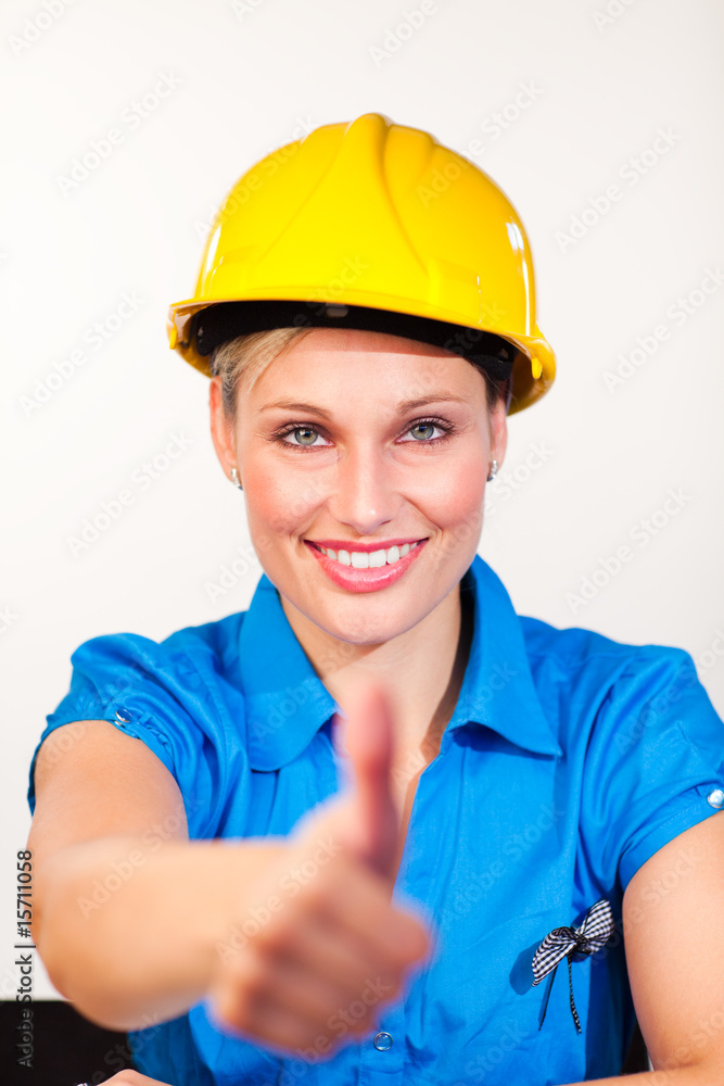 Blonde engineer smiling at the camera with thumbs up Blonde engineer smiling at the camera with thumbs up