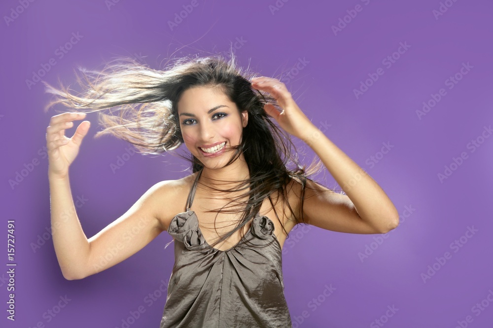 Brunette dancing at studio on purple background Brunette dancing at studio on purple background