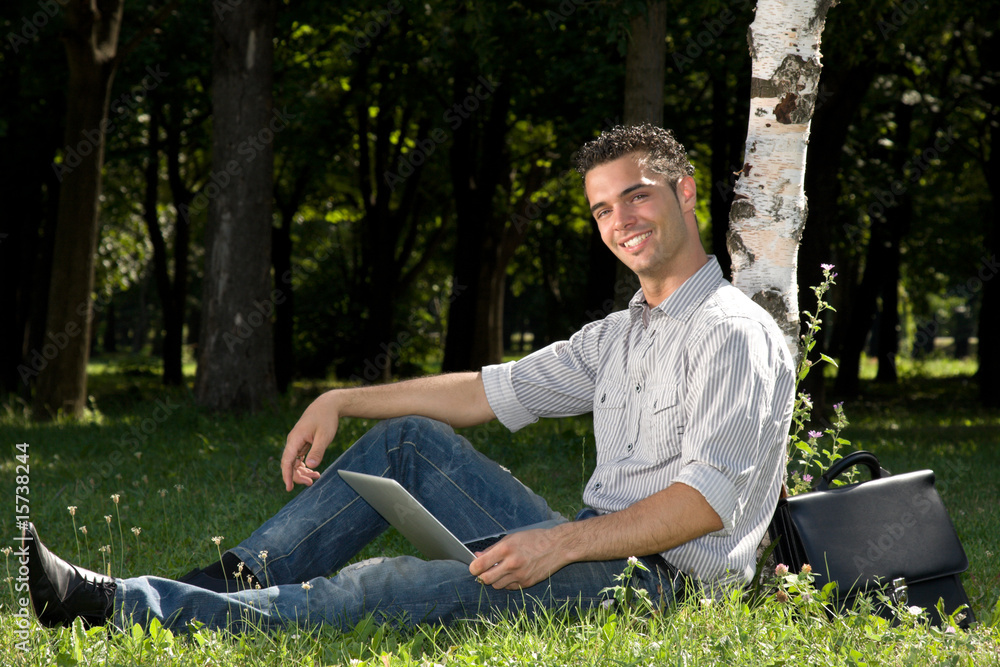 happy businessman working with laptop in the park happy businessman working with laptop in the park