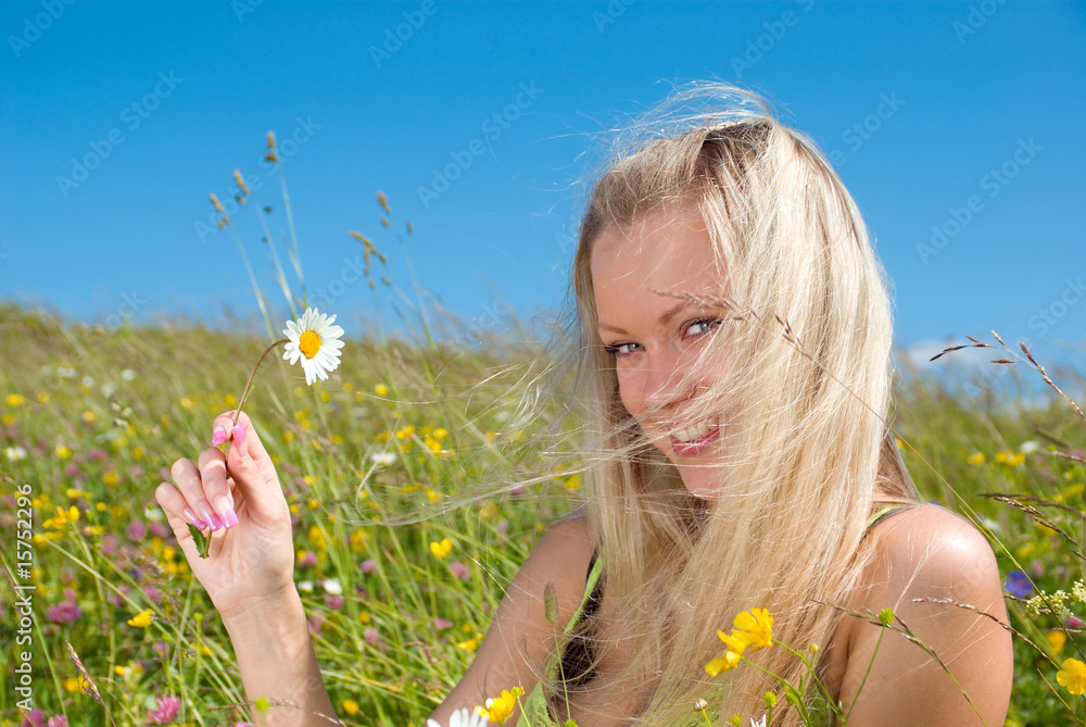 Sexy blonde on green meadow with camomile Sexy blonde on green meadow with camomile