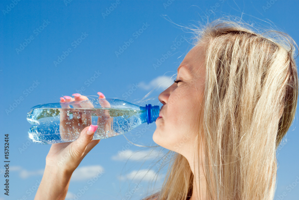 Beautiful blond girl drinking water Beautiful blond girl drinking water