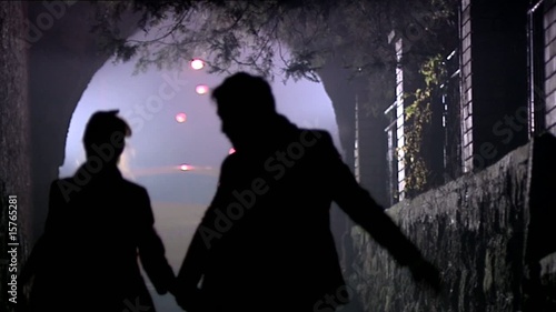 Silhouette of two people runing through the secret pass