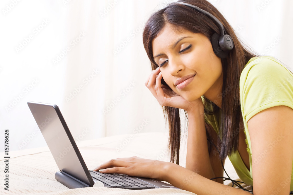arabian woman enjoying music on bed arabian woman enjoying music on bed