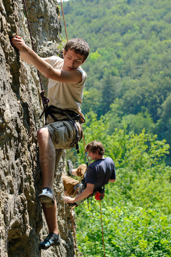 young sportsman climbing on the rock