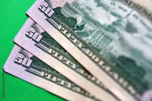 three 50 dollars banknote on the green background