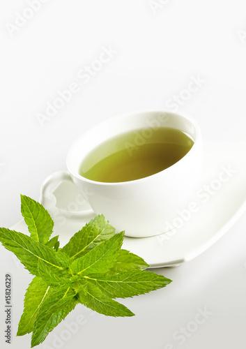 cup of mint tea and fresh leaves