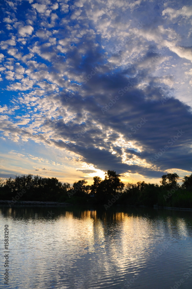 cloudscape at sunset over a lagoon