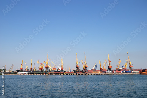Panorama of trading seaport with cranes