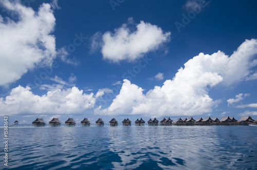 Tropical island resort on crystal clear water. photo