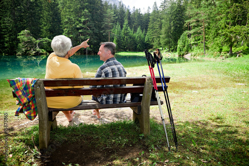 senior couple relaxing at mountain lake