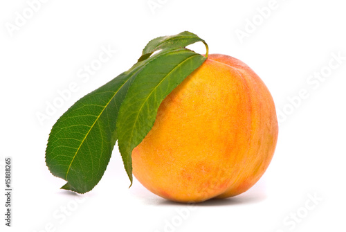 Peach fruit with green leafs isolated on white background