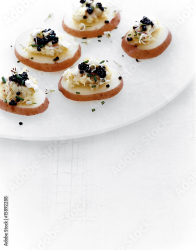 cod with caviar on steamed poatatoes, appetizer photo