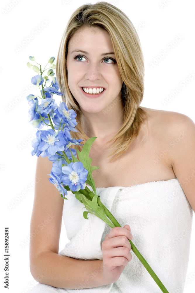 Female model holding a blue flower on a white background Female model holding a blue flower on a white background