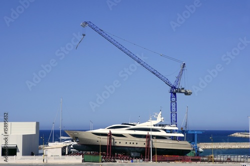 Beached boat with crane on storage area