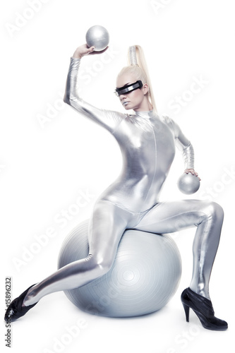 Beautiful cyber woman sitting on a silver ball