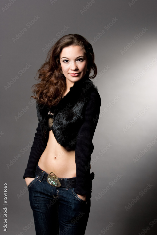 seductive young girl with hands in pockets separated over gray seductive young girl with hands in pockets separated over gray