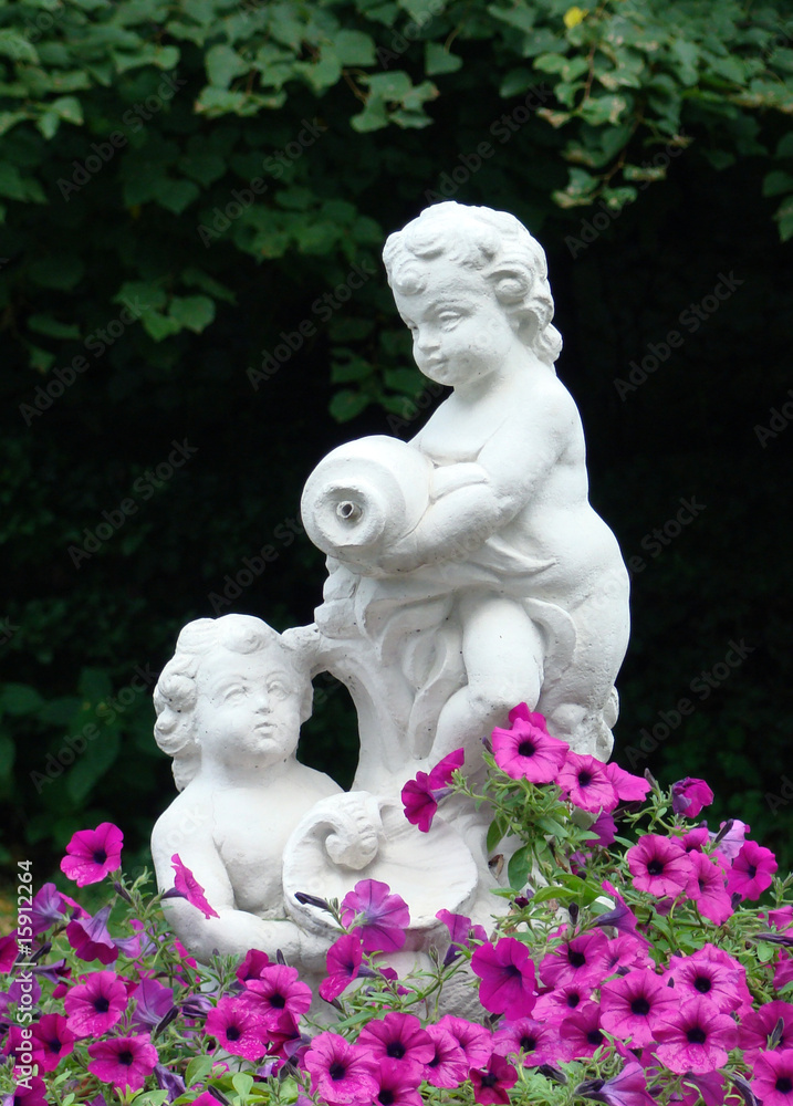 sculpture of children in a flowerbed from pink petunias sculpture of children in a flowerbed from pink petunias