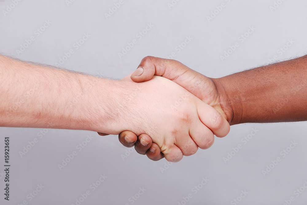 Two hands shaking, black and white on background Two hands shaking, black and white on background