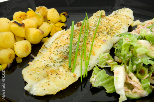 Plate with fish, potatoes and lettuce photo