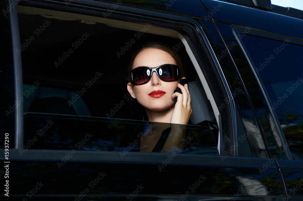 Portrait of beautiful business woman inside the limo car