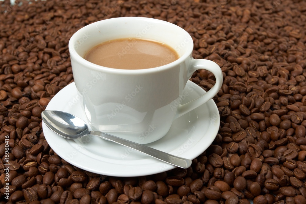 Cup with coffee, costing on coffee grain Cup with coffee, costing on coffee grain