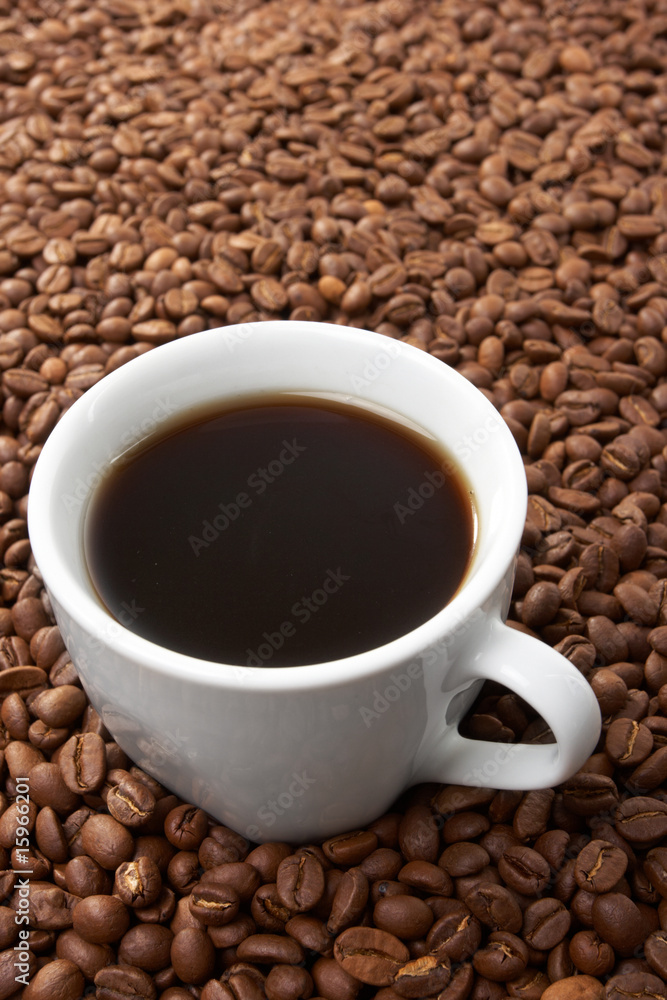Cup with coffee, costing on coffee grain Cup with coffee, costing on coffee grain