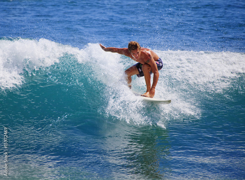 young man surfing at Point Panic, Hawaii © tomas del amo