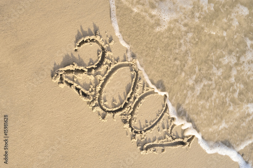 Inscription "2009" on sand