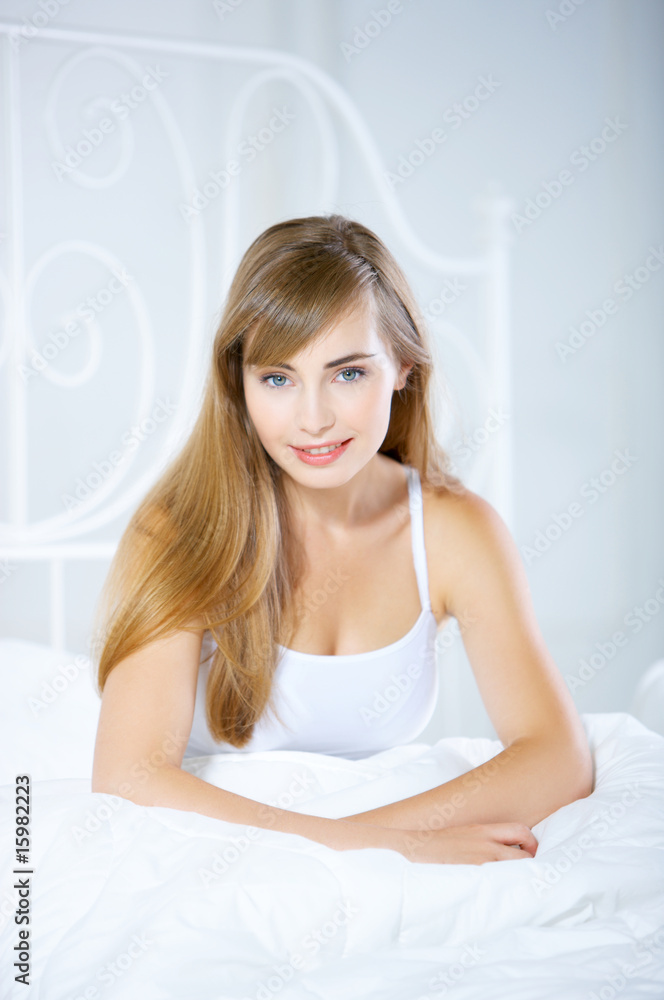 Beautiful teenager on white bed at her home Beautiful teenager on white bed at her home